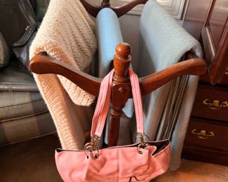 Quilt rack, throw blankets and pink handbag