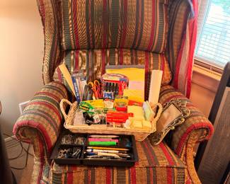 Striped upholstered wingback chair and office supplies