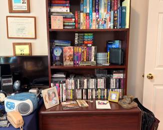 Bookcase with books, VHS tapes and cassettes
