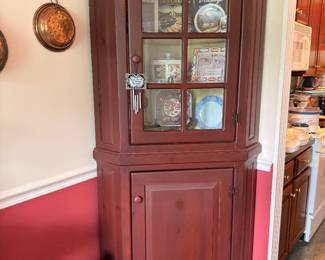 Antique red painted corner cupboard with glass doors