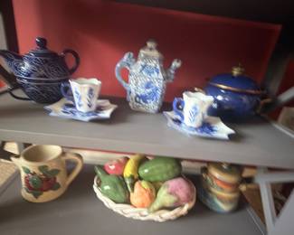 Blue and white teapots, cups and majolica fruit basket