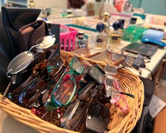 Basket of eyeglasses and perfume bottles