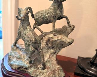 Bronze bighorn sheep sculpture on wood base