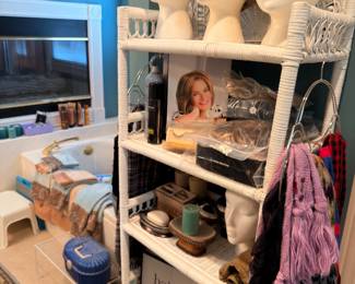 Wigs on mannequin heads and white wicker shelf