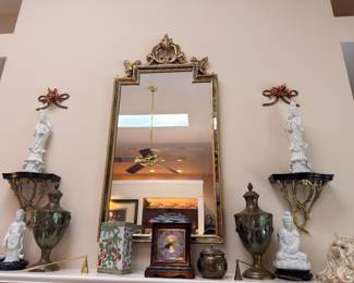 Gilt wall mirror, urns and blanc de chine figures