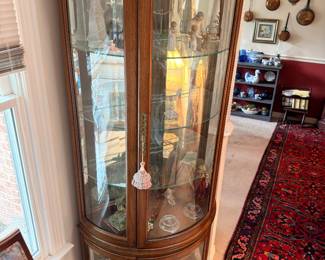 Tall oak curved glass curio display cabinet, lighted