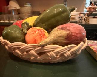 Ceramic decorative fruit in woven bowl
