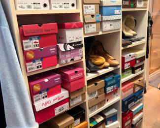 Shelves of shoes in boxes, many pairs