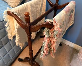 Mahogany quilt rack with throw blankets