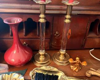 Brass candlesticks, crumb sweeper and red vase