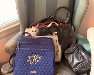 Leather handbags on striped wingback chair