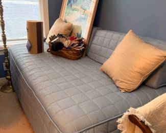 Twin bed with quilted coverlet and pillows
