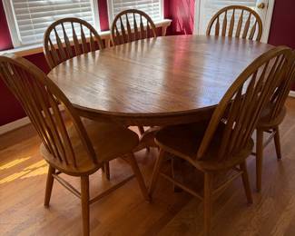 Solid Oak Dining Table with center leaf and six chairs.