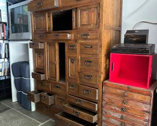 An open-drawer view of the antique Japanese choba tansu (merchant's chest) originally made for shopkeepers and traders. Used to store documents, ledgers, and shop goods. Multiple graduated drawers and sliding compartments; hand-forged iron hardware. 48"W x 19"D x 67"H.