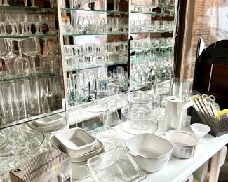 Glassware including sets of vintage French bistro or cafe wine glasses made in France, clear glass cake stands, liqueur glasses, Cointreau cocktail mixing pitchers, and more; ceramic casserole dishes