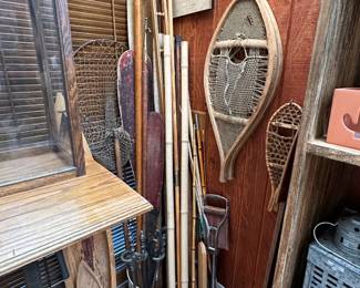 Vintage Native American snowshoes, vintage/antique fishing landing net, a vintage whaling harpoon or spear gig, some vintage paddles and oars; a vintage shooting stick or folding walking stick chair, a galvanized steel lantern, a vintage cast iron fireplace tool set