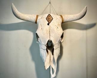 A hand-decorated cow skull (or steer skull) wall hanging for that rustic or Western-style home decor