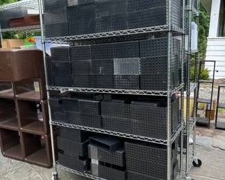 Two heavy-duty wire shelving units on rolling casters, and filled with Like-it Bricks storage bins in the harder-to-find opaque black colorway
