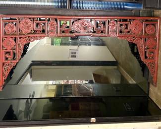 A gorgeous large antique Chinese carved, red painted and gilt wood canopy from a wedding bed chamber, with detailed relief carved panels of central floral cartouche, flanked by two phoenixes and panels depicting flowers, auspicious objects such as Shou characters, a basket of peaches wishing longevity, cranes (known to mate for life) and pomegranates that connote blessings for many children and future generations. The two phoenixes together represent the male Feng and female Huang, symbolizing eternal love, peace, and harmony.