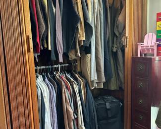 Men's clothing including wool sweaters (cashmere, merino, etc.), vintage trench coats, dress shirts and sport shirts; jackets, jeans, trousers, many in large sizes; and a black rolling luggage bag carry on.