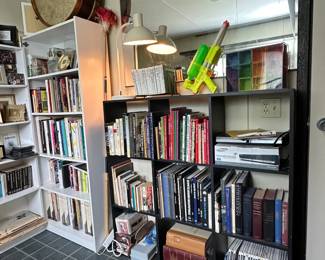 Lots of books to browse including art, history, military, nautical, holiday, design, illustration, and more; a bright neon yellow and green Nerf Super Soaker XP50-AP Water Blaster; bookshelves, decorative picture frames, an antique field drum or marching drum, and a Samsung Digital HDTV Receiver