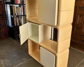 A Kay Leroy Ruggles Modular Umbo Storage Unit from the 1970s, with modular "Space Age" design and made from cream and yellow ABS plastic. 33-1/2"W x 12"D x 50"H.