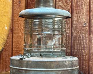 A large vintage ship's lantern marine light, with galvanized steel body and a clear, ribbed Fresnel glass lens; converted to electric