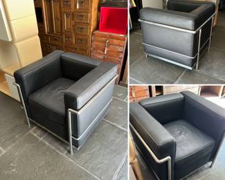 A Le Corbusier style LC2 armchair with black cushions and chrome-finished steel frame