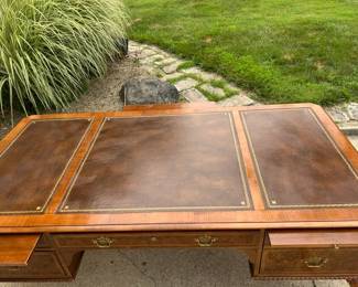 Leather top - excellent condition. 3 total sliding shelves - 2 on desk side. 1 opposite.