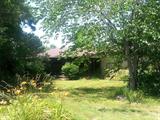 1450 sq. ft. brick veneer and siding home on 1 +/-acre. Home features good garden spot, paved driveway, covered front porch, two car attached garage, 3 bedrooms and 2 baths. Newly updated bathrooms, custom cabinets, separate laundry room.