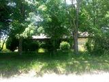 1450 sq. ft. brick veneer and siding home on 1 +/-acre. Home features good garden spot, paved driveway, covered front porch, two car attached garage, 3 bedrooms and 2 baths. Newly updated bathrooms, custom cabinets, separate laundry room.