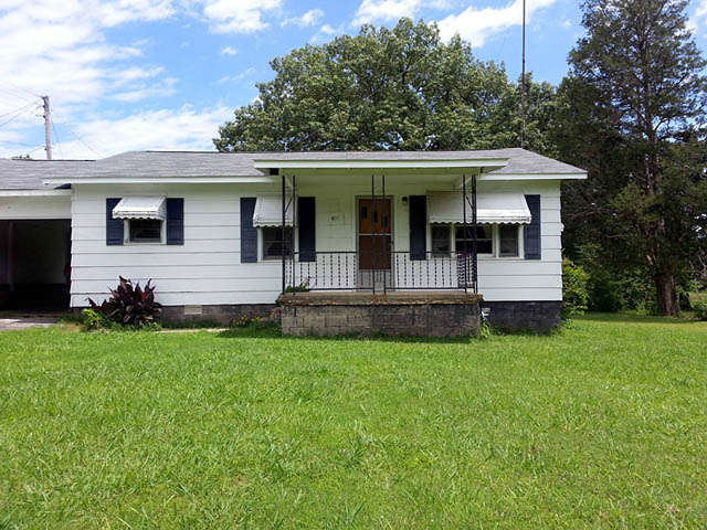 1000+/- sq. ft. siding frame home on large city lot. Home features 2 bedrooms – 11 x 15 and 13 x 16, 1 bath, kitchen with dining area, 15 x 12 living room, and separate laundry room. hardwood floors, gas heat, window ac. attached covered carport, paved driveway, nearly new roof, New electric water heater, nice garden spot, nice shady back yard. Home appears to be in sound condition and move-in ready.