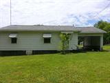 1000+/- sq. ft. siding frame home on large city lot. Home features 2 bedrooms – 11 x 15 and 13 x 16, 1 bath, kitchen with dining area, 15 x 12 living room, and separate laundry room. hardwood floors, gas heat, window ac. attached covered carport, paved driveway, nearly new roof, New electric water heater, nice garden spot, nice shady back yard. Home appears to be in sound condition and move-in ready.