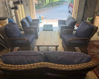 Two sets of outdoor furniture, both having a couch, two chairs and table.