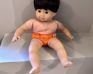 American Girl Bitty Baby doll is a retired boy model featuring dark brown hair, brown eyes, and light skin