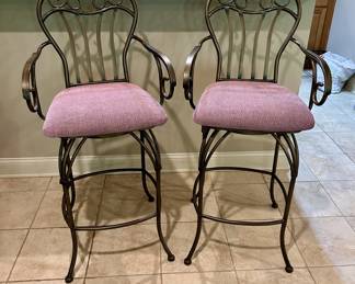 Pair of scrolled metal swivel bar stools