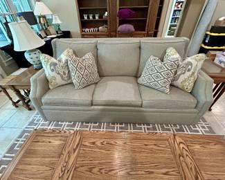 Gray upholstered 3-cushion sleeper sofa with air mattress mechanism