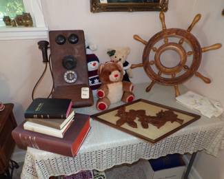 vintage wall telephone ,hand carved ships wheel, bibles
