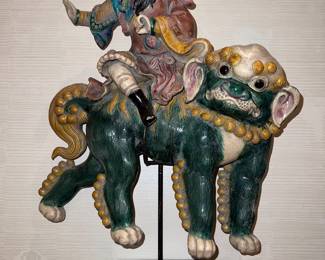 Chinese mythological warrior riding a Foo Dog