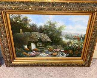European-style thatched roof cottage in a lush floral garden