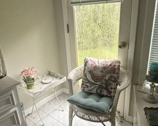 White Wicker Armchair with Floral Pillow and Teal Cushion