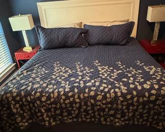 Navy Blue Botanical Leaf Pattern Quilt Set with White Panel Headboard, Red Wicker Nightstands, and Table Lamps