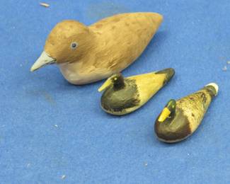 Lot 373. Two miniature wooden ducks and a miniature bird carved by Bob Krenz