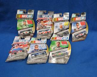 Lot 80. Seven NASCAR Hot Wheels-style cars sealed in packages