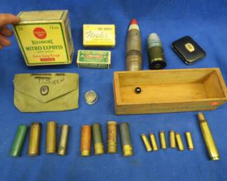 Lot 352. Many collectibles including old brass 12-gauge casings, a Remington 12-gauge box in excellent condition, military projectile, 2003 DU pin, and. more