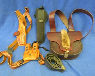 Lot 359. Two leather holsters, and leather and fur shooting accessories bag, and more