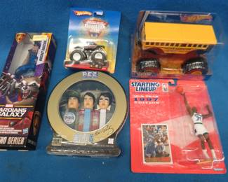Lot 73. Five NIP collectible toys: Three Elvis Pez dispensers. Two Hot Wheels Monster Jam items: Higher Education and American Guardia. 1997 Kevin Garnet figure and trading card. marvel Guardians of the Galaxy