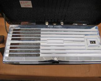 Lot 295. Old radio for parts or repair, vintage Polaroid camera, and more