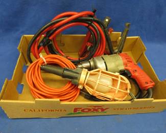 Lot 430. Milwaukee drill, work light, and jumper cables. The drill and light work