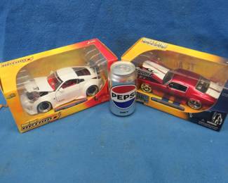 Lot 75. Two Jada Toys 1:24 die cast cars: Big Time Muscle 1971 Chevy Camaro. Import Racer Nissan Z
